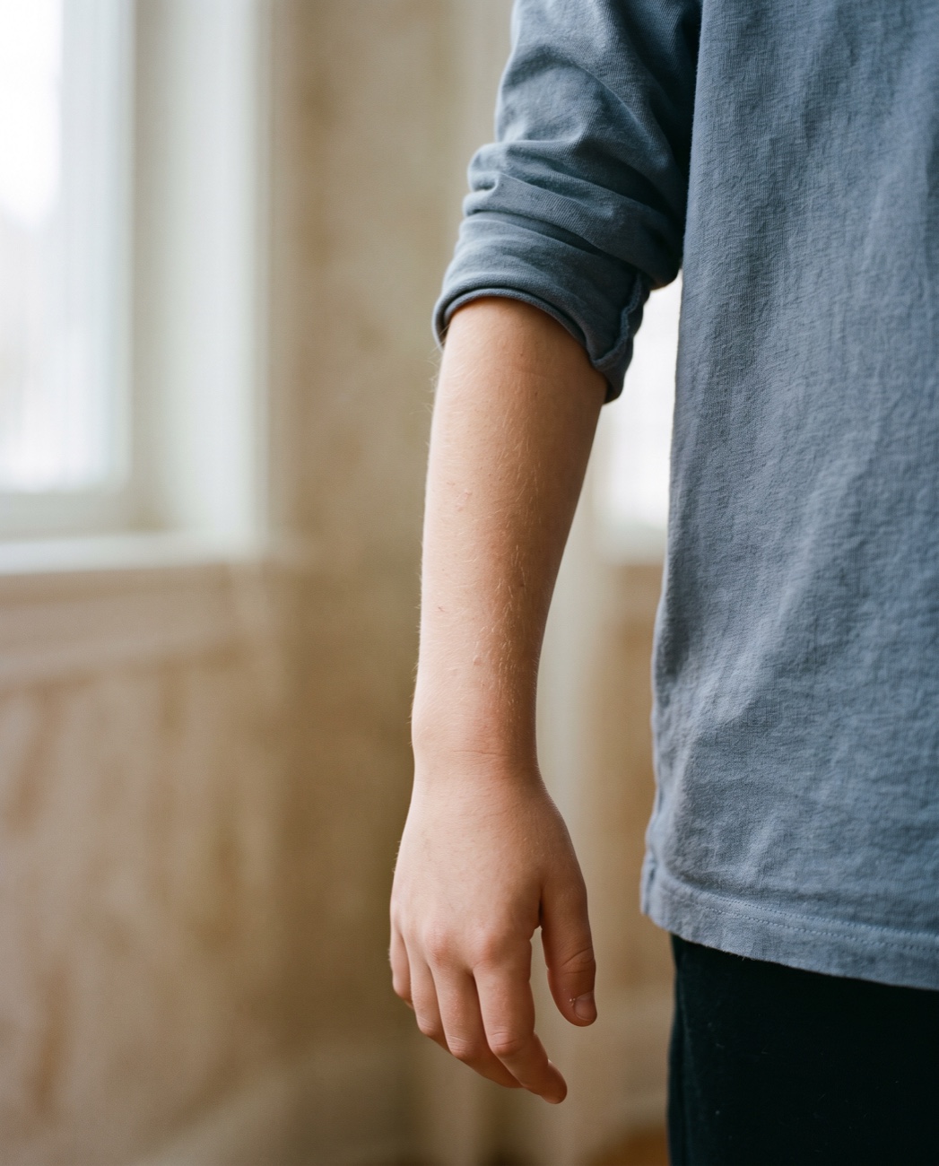 A child's bare wrist, nothing worn on it